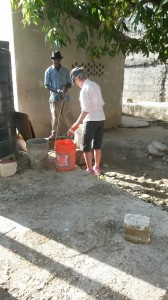 Mary getting buckets of water for the cement
