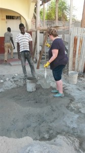 Caroline filling buckets with cement